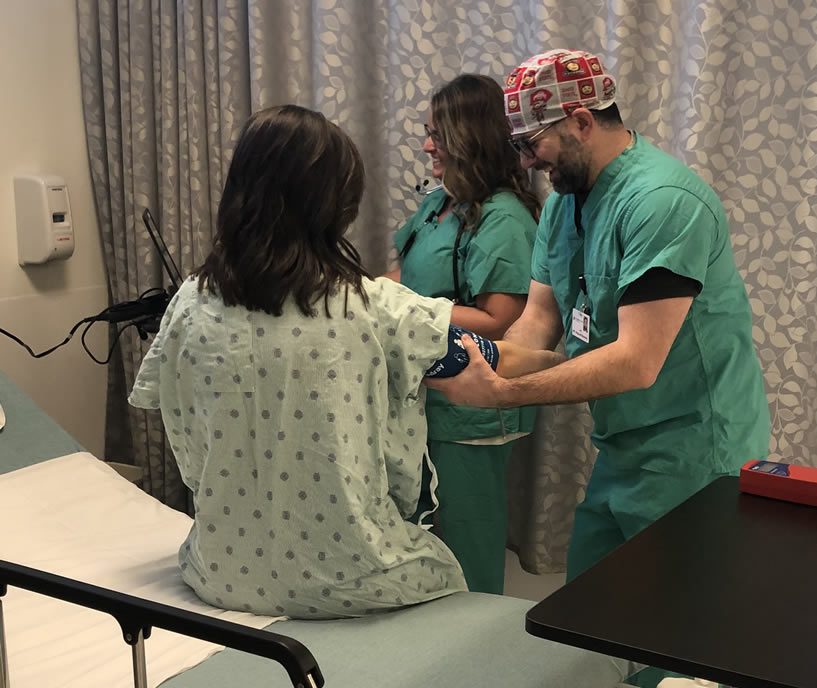 Two medical professionals checking blood pressure of a patient before surgery.